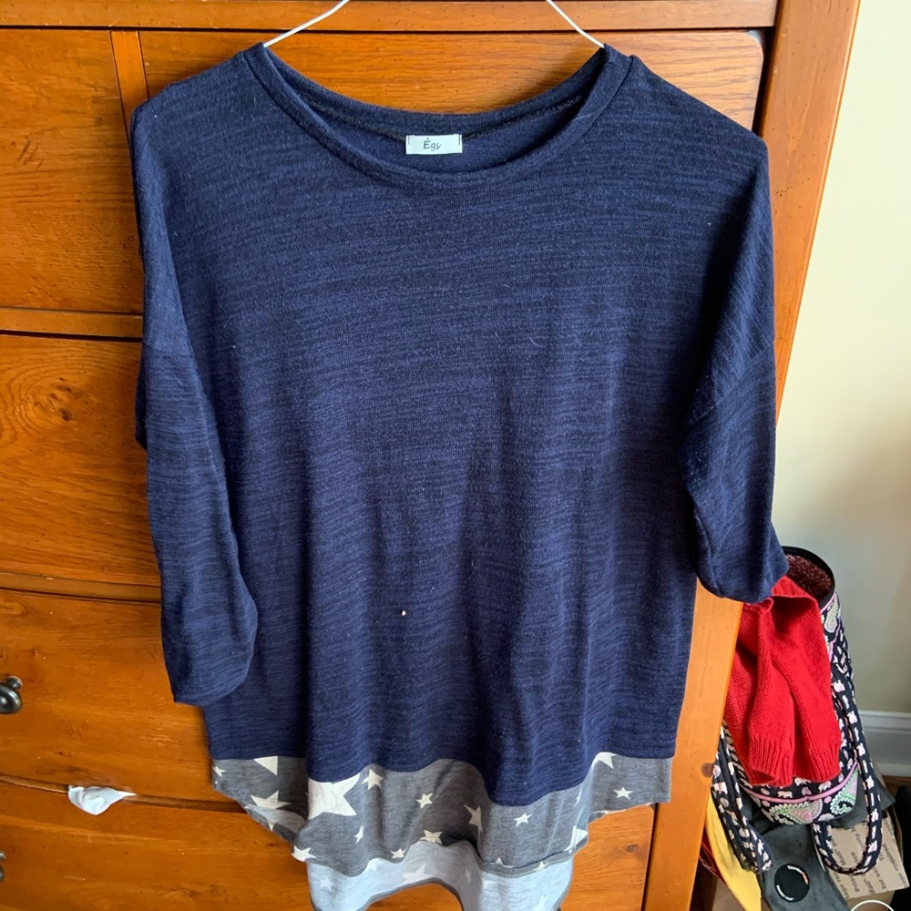 Blue knit sweater with stars on bottom accent